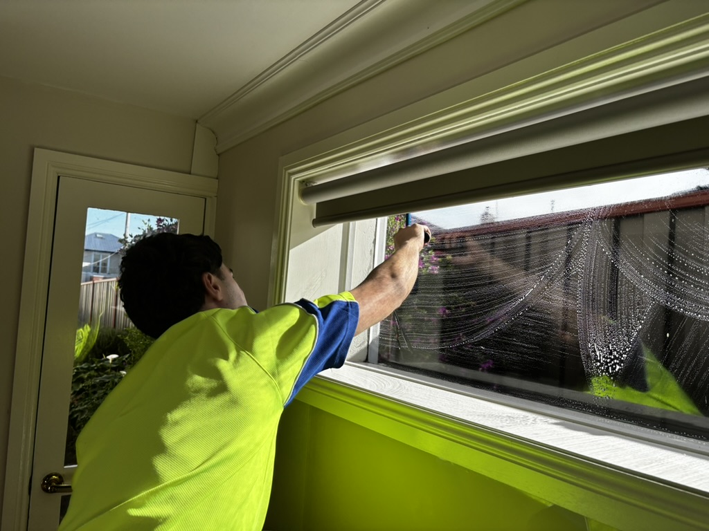 Matthew cleaning an interior window